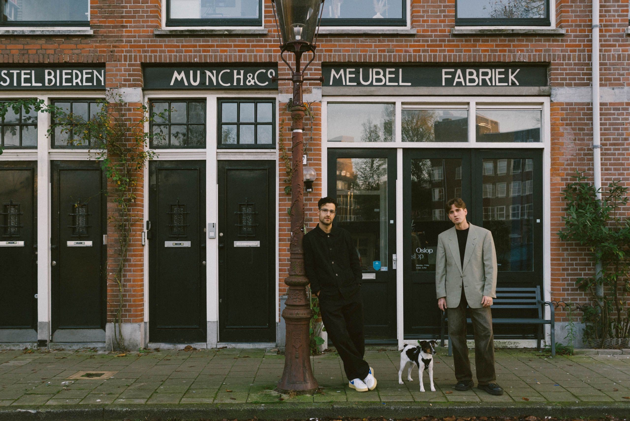 The founders of Oslop Studio — Peter (left) and Zoli — outside their Amsterdam base, joined by their canine co-worker, Ruby.